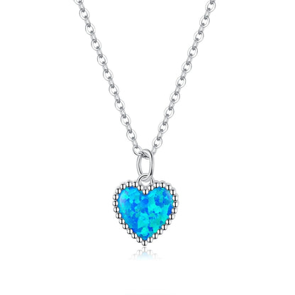 Sterling silver heart pendant necklace with deep blue faceted gemstone bezel
