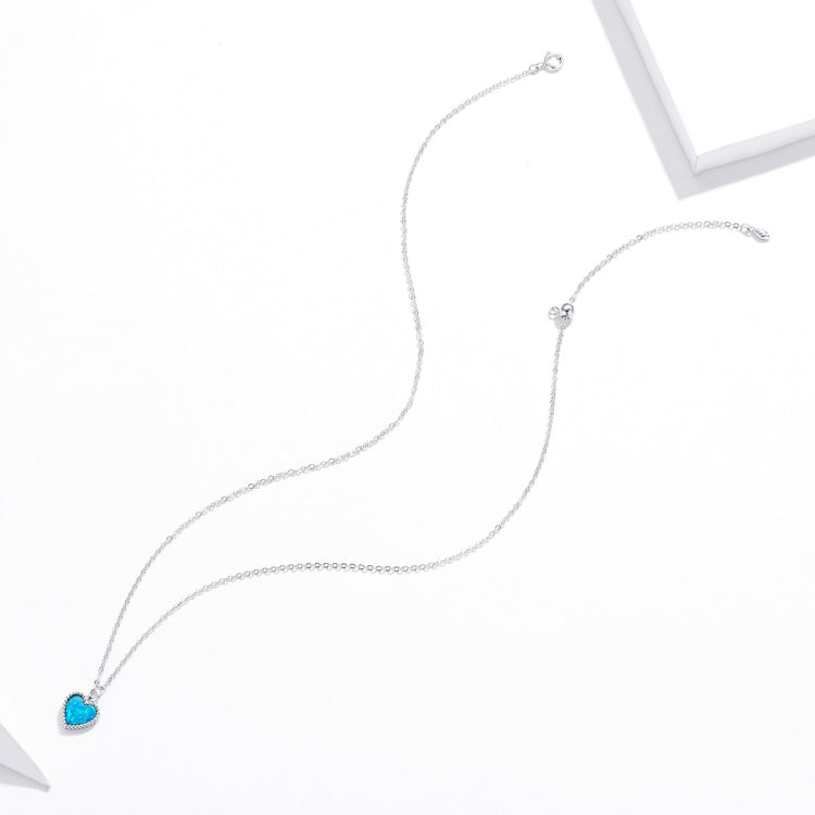 Sterling silver chain necklace with small blue heart charm at end