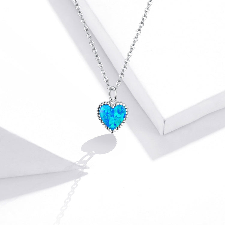 Sterling silver necklace with deep blue heart pendant and scalloped beaded border