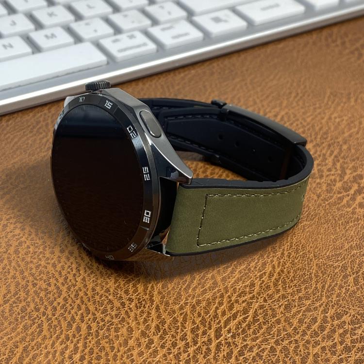 Green stitched watch band fitted to a round black smartwatch