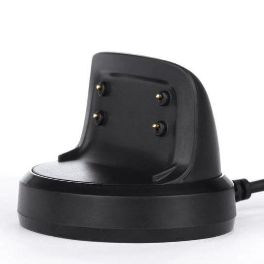 Side view of black charging dock showing four gold pins for a Gear Fit2 smartwatch