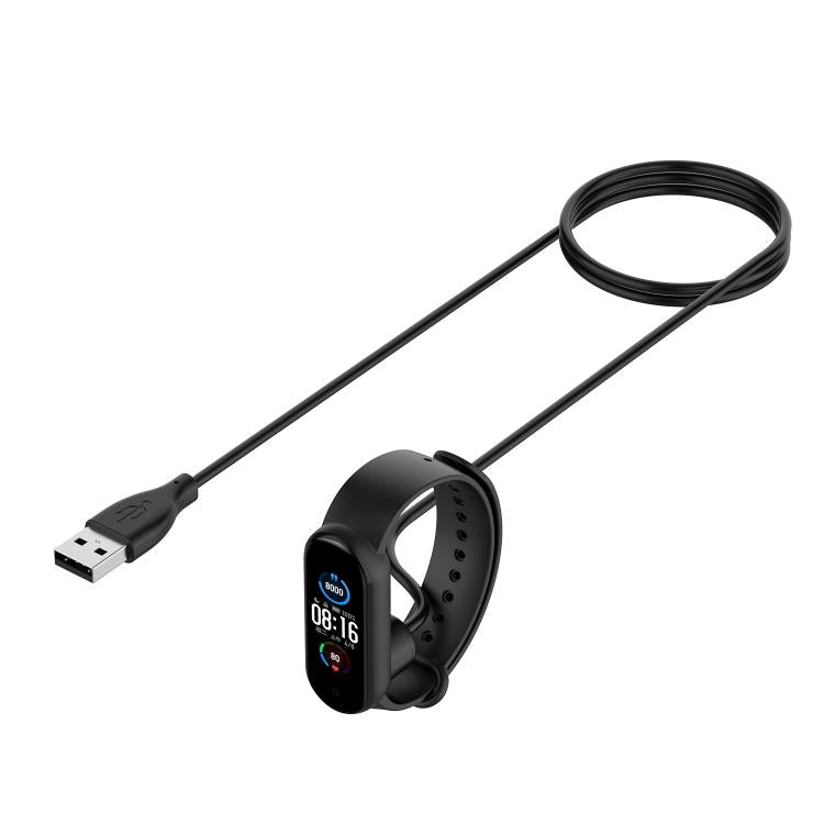 Black magnetic charging cable connected to a fitness band