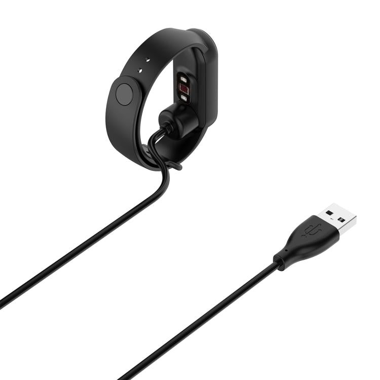Black charging cable connected to the back of a fitness band