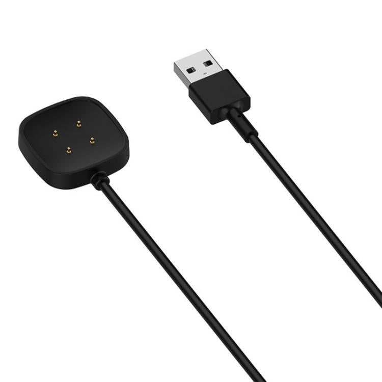 Close-up of the black cable's four-pin magnetic watch charging pad and USB-A plug
