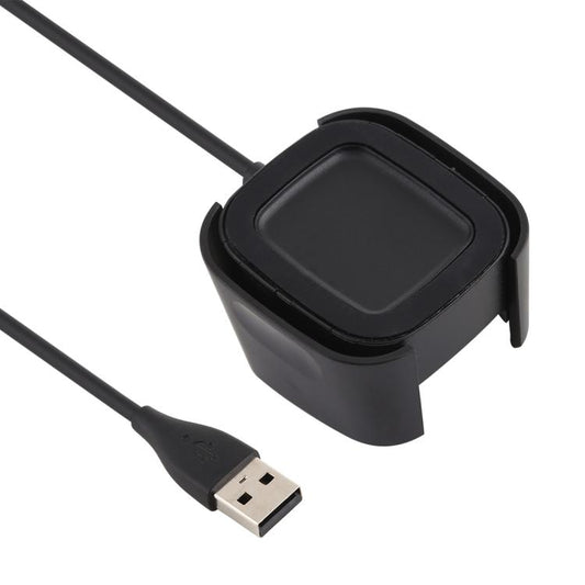 Black Fitbit Versa 2 charging dock shown from above with its charging surface and USB-A cable