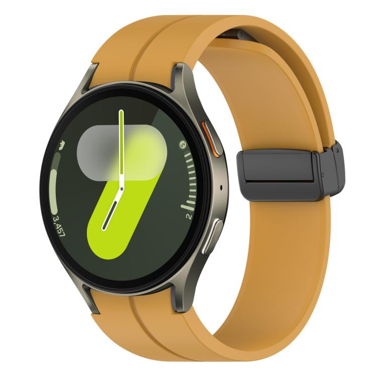 Mustard yellow silicone Samsung watch band with black magnetic buckle on a smartwatch