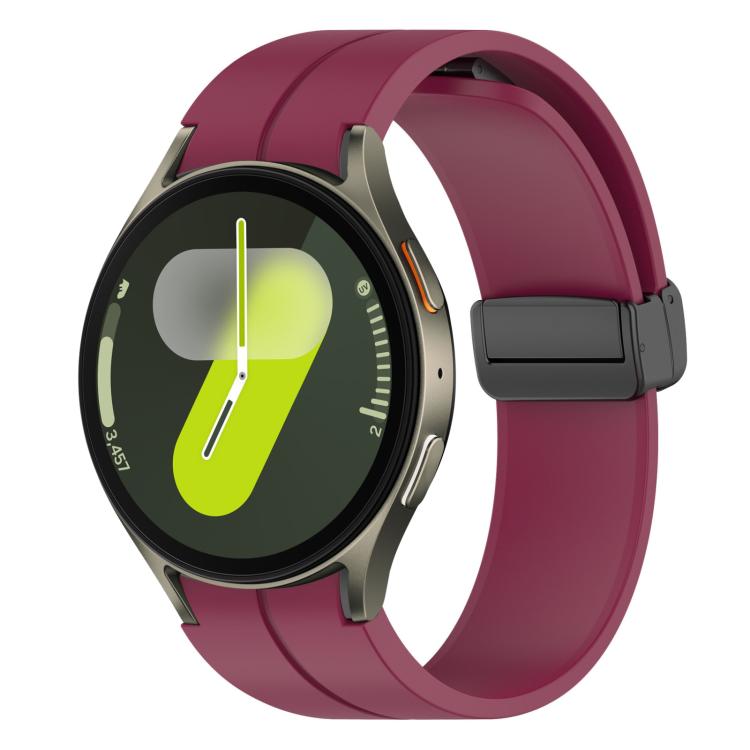 Wine red silicone Samsung watch band with black magnetic buckle on a smartwatch