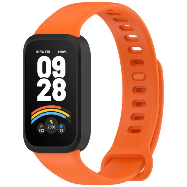 Orange silicone watch band with black fitness tracker and perforated adjustable strap
