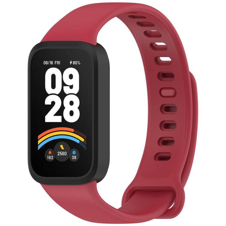 Red silicone watch band with black fitness tracker and perforated adjustable strap