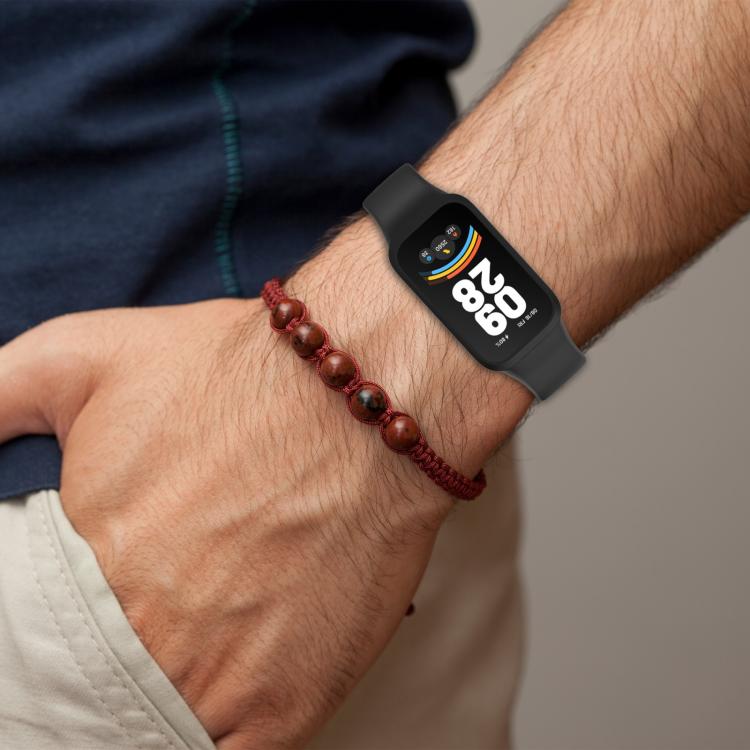 Black integrated silicone watch band worn on a wrist