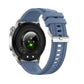 Smartwatch with a blue silicone strap, silver case, and rear heart rate sensor.