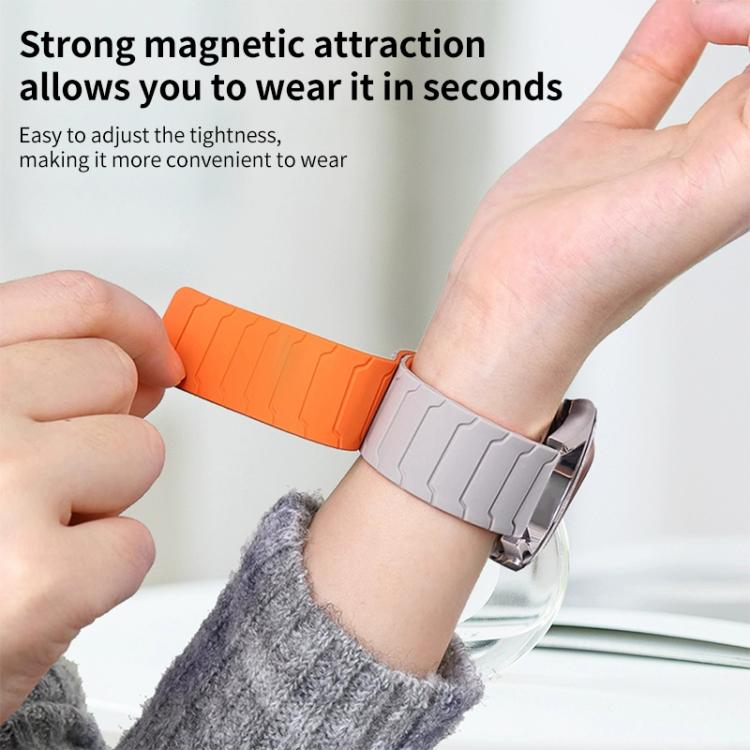xDfind two-tone orange and light gray silicone watch band worn on a wrist