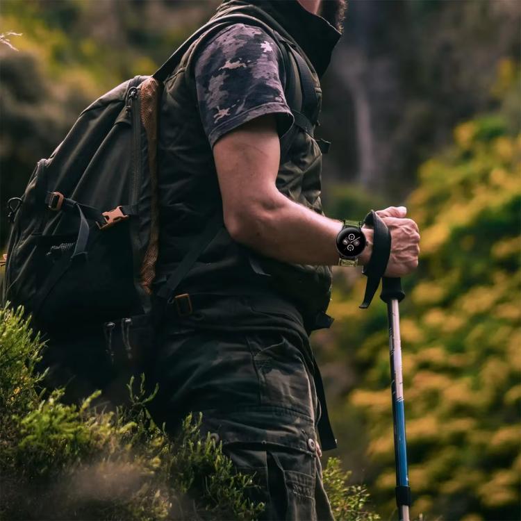 Black watch band worn with a round smartwatch while hiking