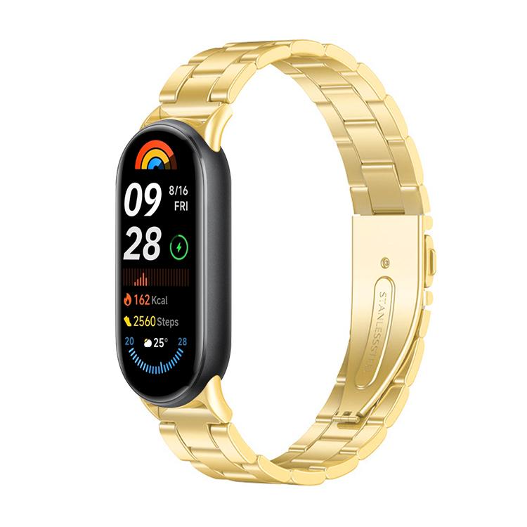 Gold metal three-bead watch band fitted to a slim fitness tracker.