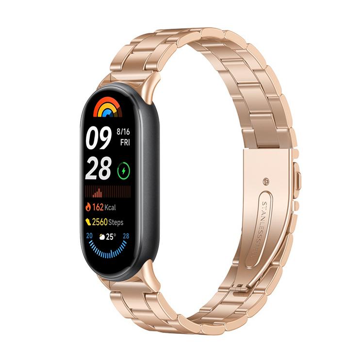 Rose gold metal three-bead watch band fitted to a slim fitness tracker.