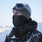 Dark hooded wind scarf covering face and neck, worn outdoors in snow