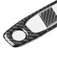 Black carbon-fiber reading light panel cover with two circular cutouts and center square