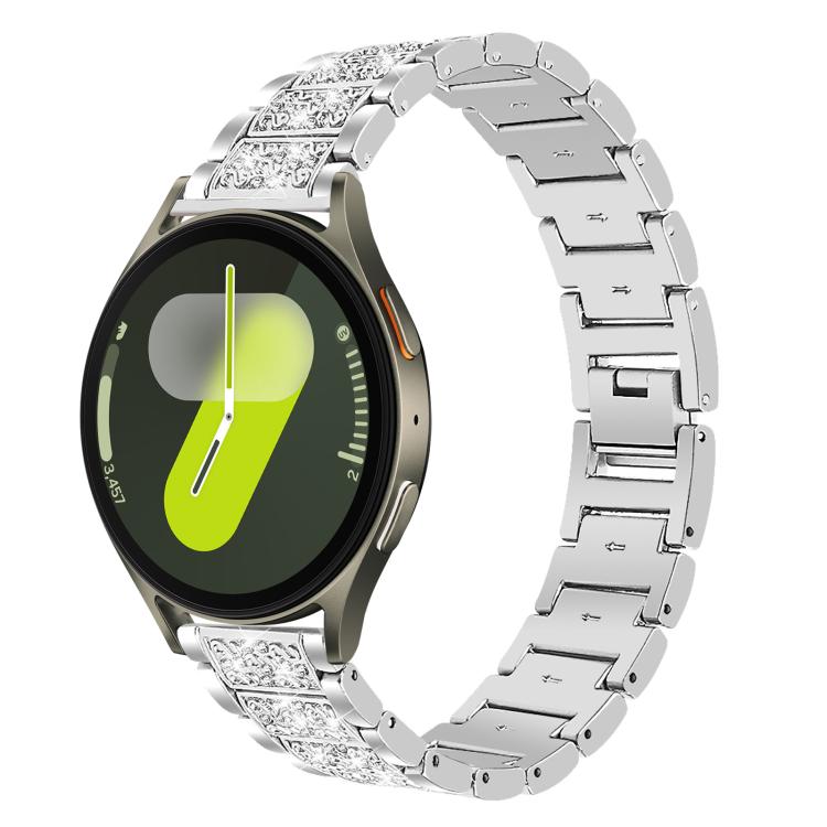 Silver jeweled stainless steel watch band fitted to a round smartwatch with a bright dial