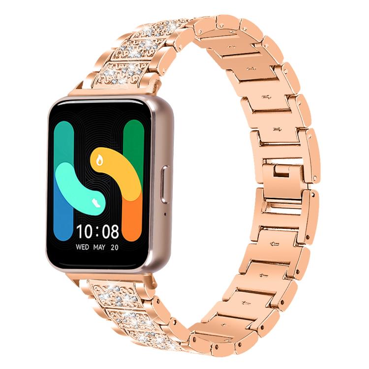 Rose gold stainless steel smartwatch band with crystal-set links, shown attached to a watch.