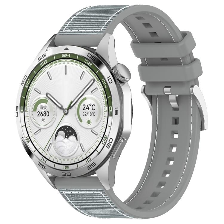 Gray hybrid nylon and silicone watch band with stitched panels and adjustable holes, shown on a watch.