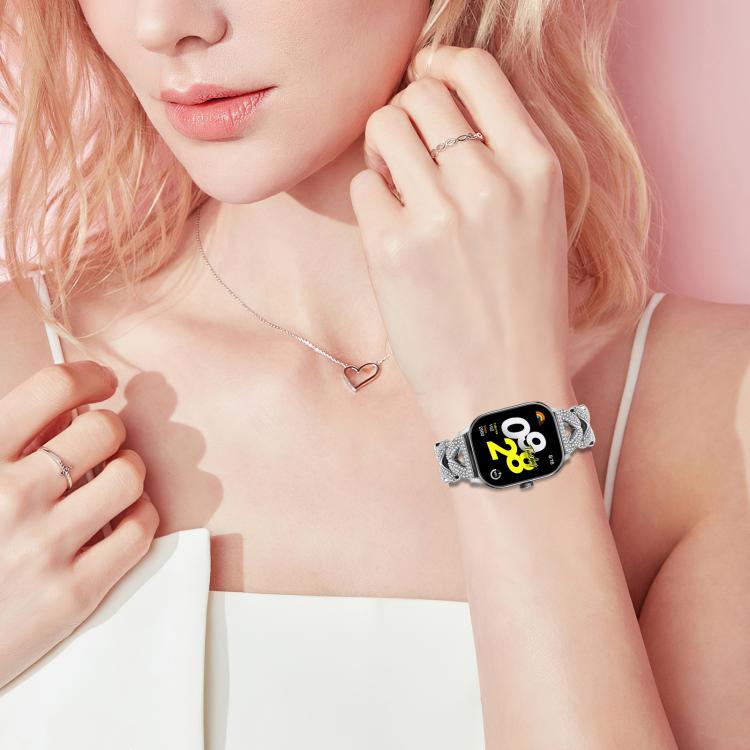 Silver crystal-link watch band worn on the wrist