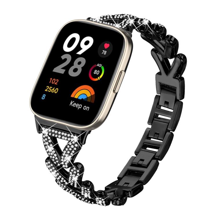 Black metal smartwatch band with rhinestone-set twisted links, shown attached to a watch.