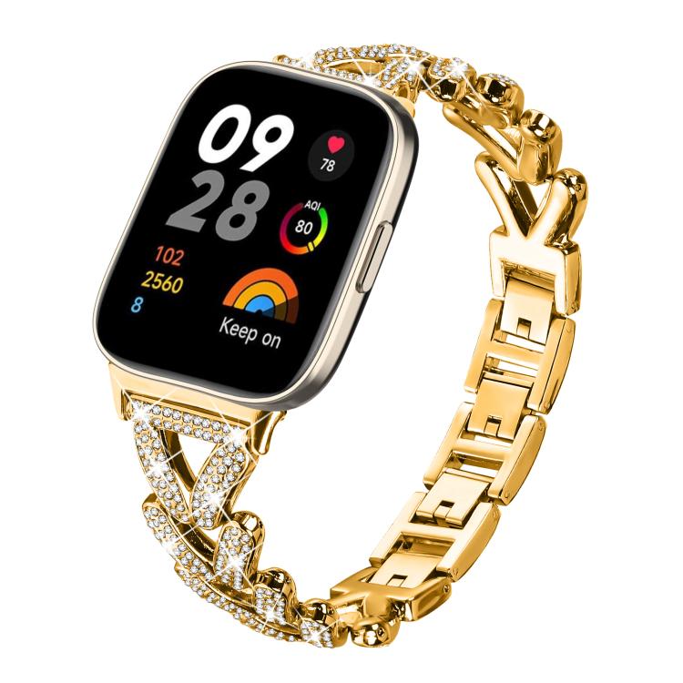 Gold-tone metal smartwatch band with rhinestone-set twisted links and geometric chain links.