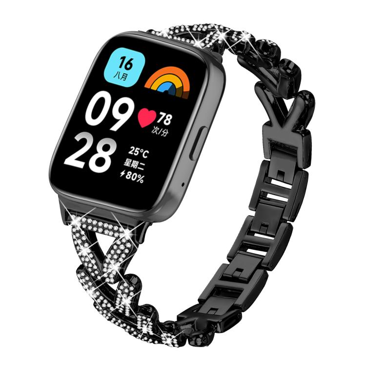 Black metal smartwatch band with crystal-studded geometric links, shown on a watch