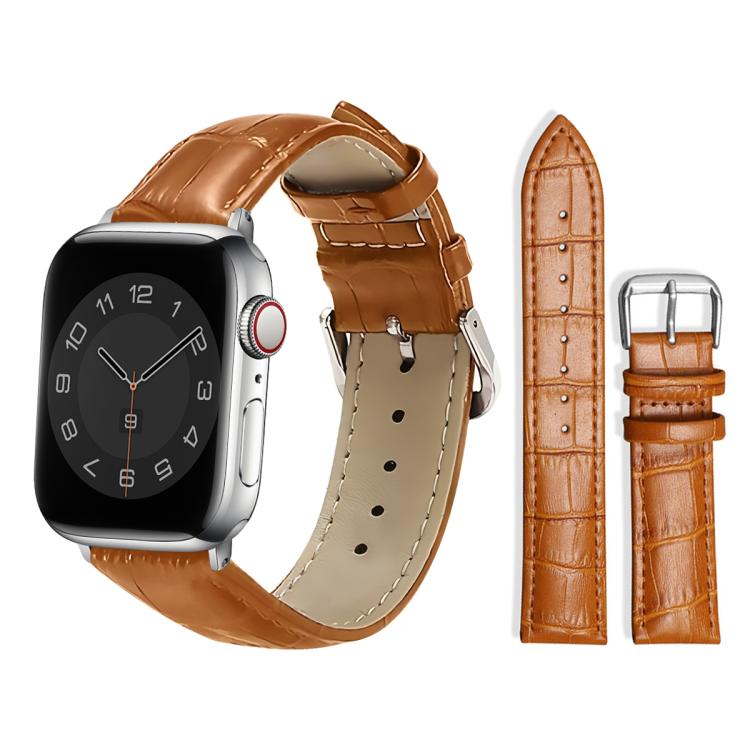 Tan leather watch strap with raised texture, adjustment holes, and a silver pin buckle.
