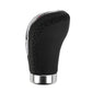 Black leather gear shift knob with stitched grip panel and chrome rim
