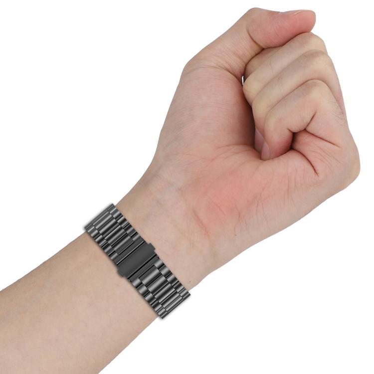 Dark gray titanium alloy watch band with flat links worn around a wrist