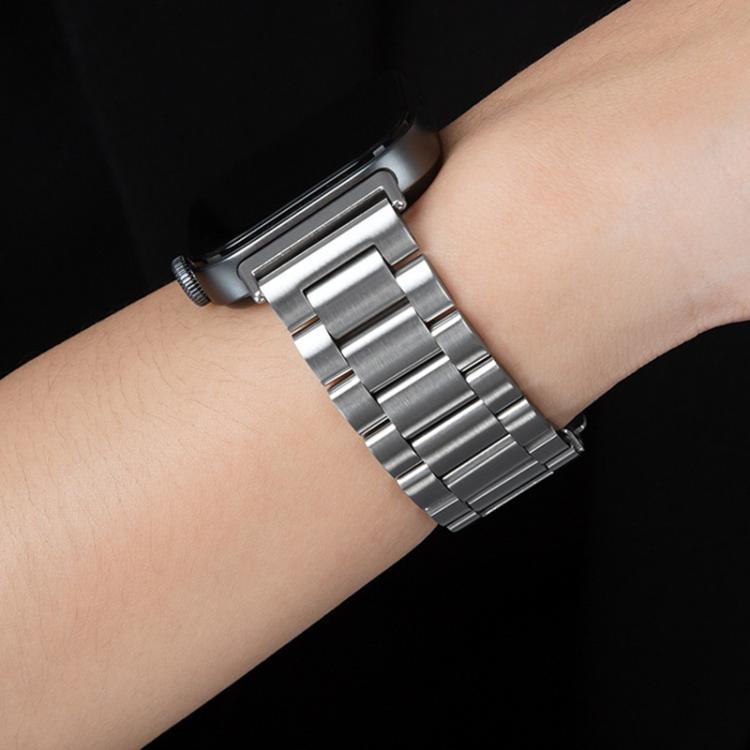 Silver linked titanium alloy watch band worn on a wrist