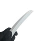 White trim removal tool tip held by black-gloved hand for prying
