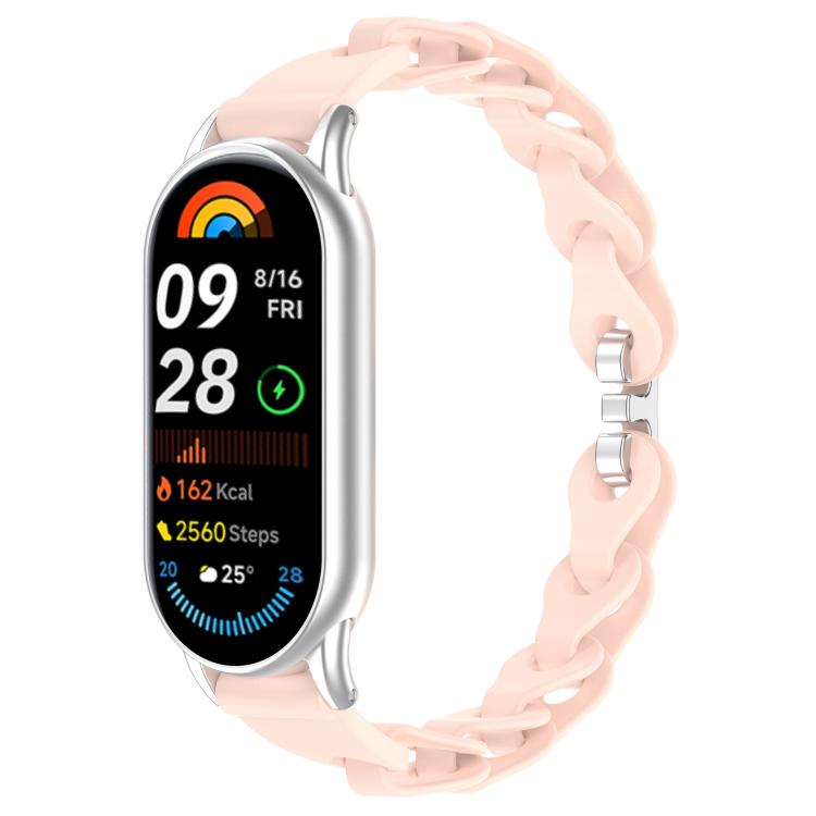 Pale pink hollow-link silicone watch band fitted to a smartwatch.