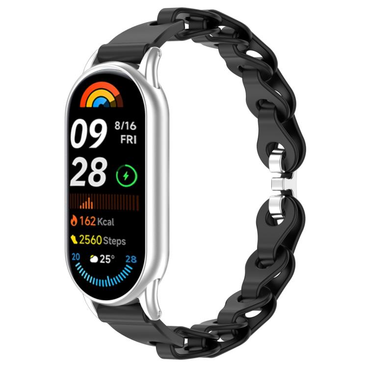 Black hollow-link silicone watch band fitted to a smartwatch.