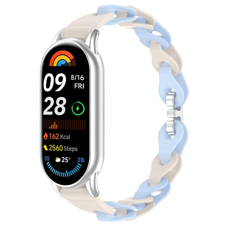Cream and light blue hollow silicone watch band on a silver Xiaomi Smart Band