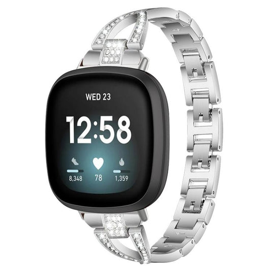 Silver metal Fitbit watch band with crystal accents shown on a smartwatch.