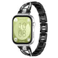 Black X-shaped metal watch band with crystal accents, shown attached to a smartwatch.