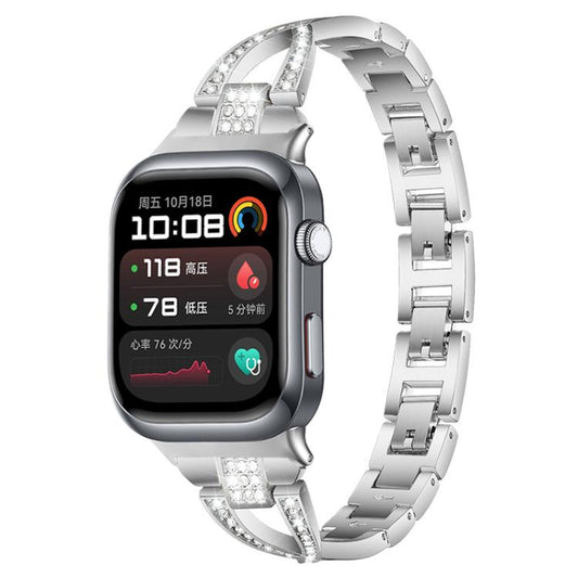 Silver X-shaped metal watch band with crystal accents, shown on a smartwatch