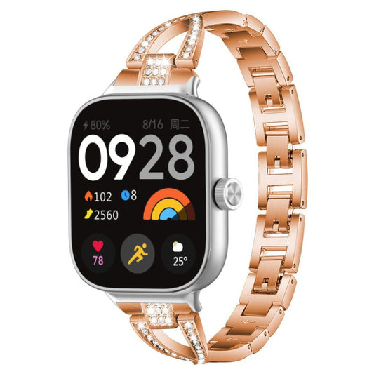 Rose gold X-shaped metal watch band with crystal accents, shown attached to a smartwatch