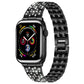 xDfind black metal Apple Watch band with five rows of clear stones, shown attached to a watch