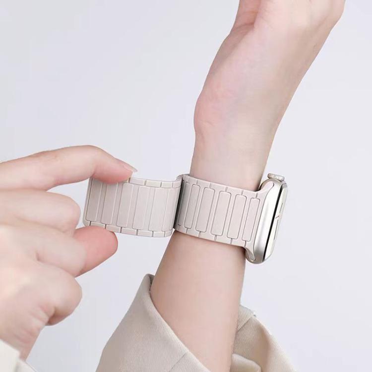 Light gray magnetic silicone watch band shown being fastened around a wrist
