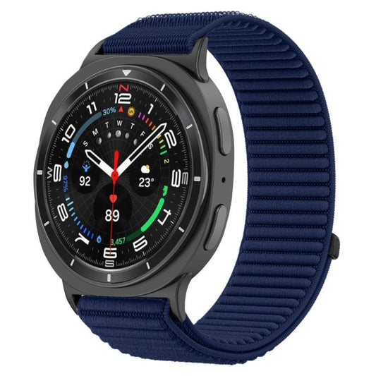 Navy woven nylon hook-and-loop watch band fitted to a dark smartwatch