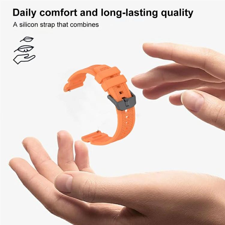 Flexible orange silicone watch band with a metal buckle