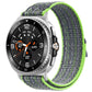 Nylon hook-and-loop watch band in gray with lime green trim, shown on a silver watch.