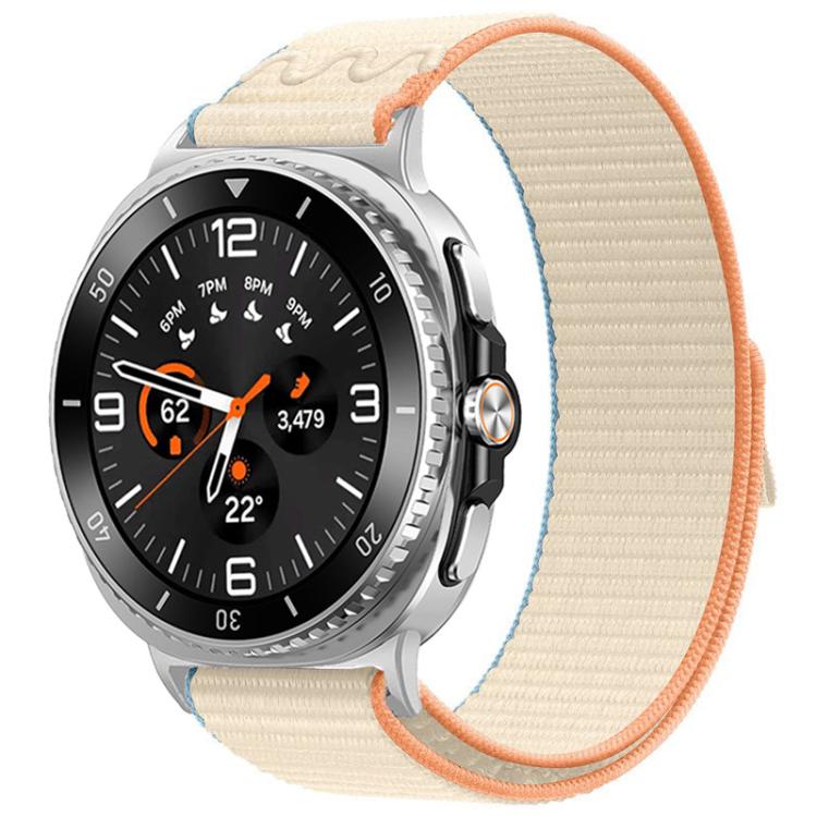Nylon hook-and-loop watch band in milky white with orange trim, shown on a silver watch.
