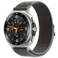 Nylon hook-and-loop watch band in charcoal gray with multicolor flecks, shown on a silver watch.
