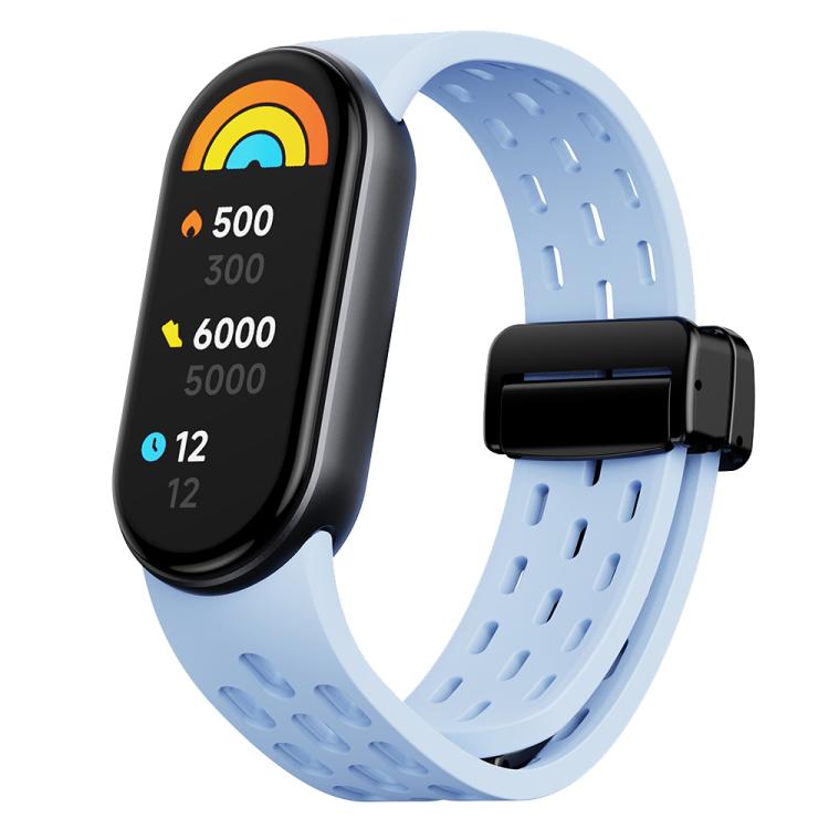 Light blue perforated silicone watch band with black magnetic clasp, shown with a fitness tracker
