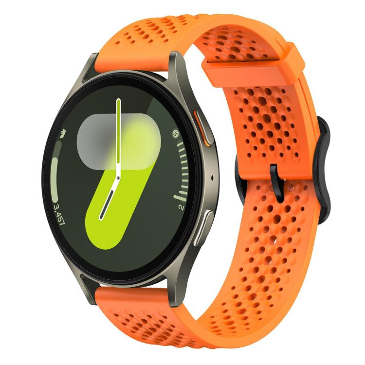 Orange perforated silicone watch band with a round smartwatch