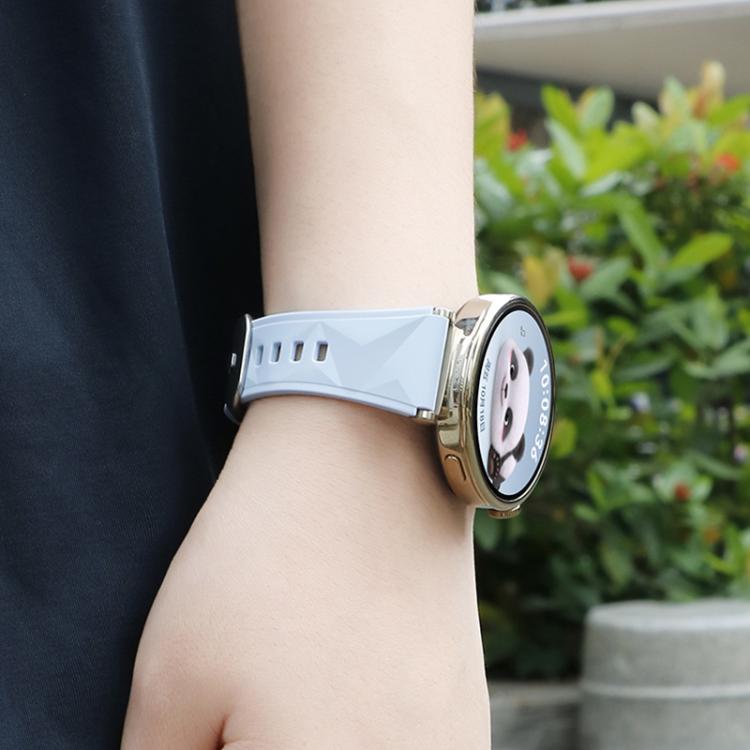 Pale blue faceted silicone watch band worn on the wrist with a gold-tone smartwatch